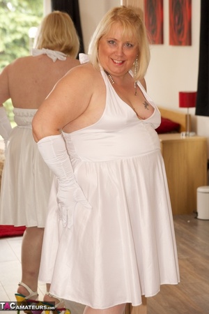 Big sized blonde in white dress and stockings teasing by the fan and showing her small breast - XXXonXXX - Pic 1