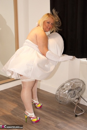 Big sized blonde in white dress and stockings teasing by the fan and showing her small breast - XXXonXXX - Pic 2