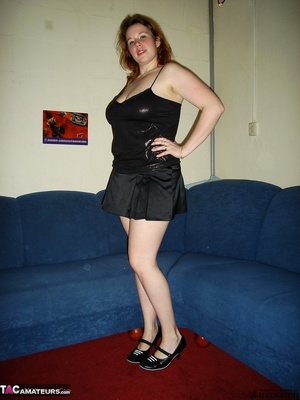 Huge breasted redhead in black top and miniskirt strips on the blue couch and show her naked goods - XXXonXXX - Pic 1