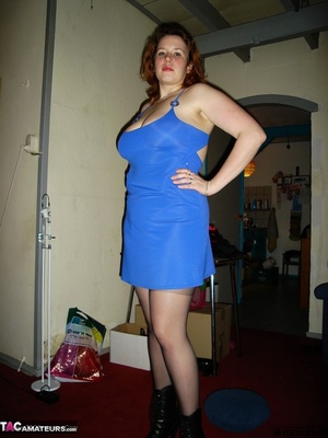 Busty redhead in black stockings and blue dress getting nude and posing naked on the red carpet - Picture 2