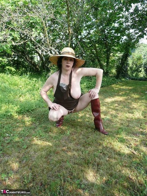 Dark haired wife with huge hooters working in the garden and showing her shaved pussy while posing in rubber boots - XXXonXXX - Pic 13