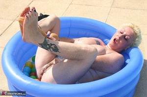 Chubby blonde with big breast dildoing her pierced vagina in the inflatable pool outdoors - XXXonXXX - Pic 17
