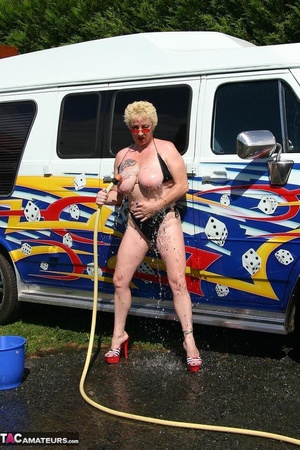 Huge boobed blonde in sunglasses and high heels washing car and her shaved coochie with water hose outdoors - XXXonXXX - Pic 9