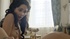 Slender natural brunette is lying under the baking sun