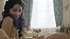 Slender natural brunette is lying under the baking sun