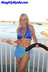 Flexible blonde milf wearing blue bra and skirt sits on the outdoor chair