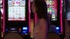 Dazed, naked woman walks slowly and aimlessly through a crowded casino.