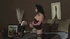 Long black haired slut in long black boots and stockings fingers her own