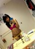 black-haired babe poses topless