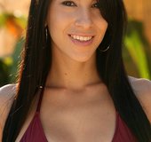 Dark haired brunette with pierced belly wiggles out of red bikini and