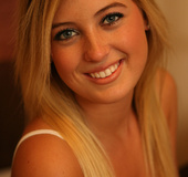 Grey eyed blonde in white underwear slowly undressing on the wide bed