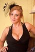 Busty blonde babe in a black dress gets kinky on the couch
