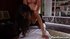 Busty curly haired slut in fishnet stockings rides a big fat cock