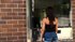 Petite brunette in black tube displays her invting figure in public