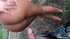A hand, tipped in white nails, wipes up cum as it drips down her round