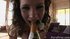 Mouth agape, she stares seductively into the camera, on her knees, gripping