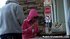 Blonde, in a pink hoodie, she gets splashed while texting on her phone