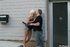 Short and bleach blonde, she struts around, wearing a skirt, on her mans'