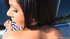Squatting by a car, holding her dress, this exotic, brunette, gets her